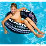 Boy floating on the inflatable monster tire ring