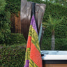 Towel holder installed on a cover lift arm and holding a towel