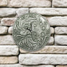silver metallic terra cotta clock. Has roman numerals, half moon with face and stars.