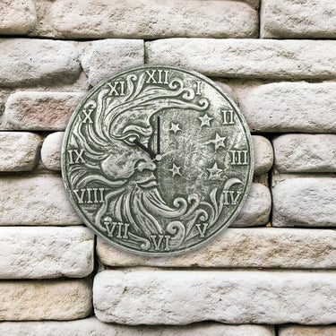 silver metallic terra cotta clock. Has roman numerals, half moon with face and stars.