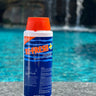5lb container of pool shock on a concrete ledge beside a pool
