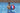 Young man standing in the pool holding the NBA inflatable Ball 24". Red white and blue with NBA Logo. For scale.