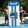 Dallas Mavericks NBA Giant Mattress - 9' 9" tall Shown with a man and a woman standing next to it for scale.