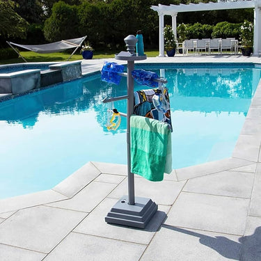 Towel rack with green towel by a poolside