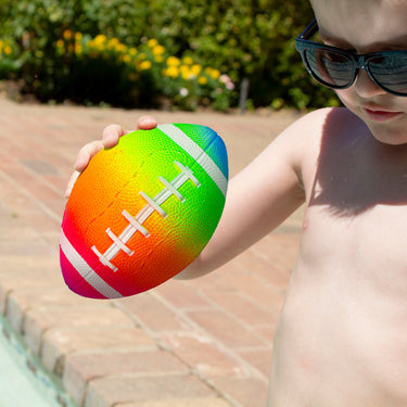 Child holding 7" football in one hand, for scale.