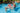 Very large rainbow color zebra pool float. Shown with 2 children riding zany zebra and mom standing next to him in the water.