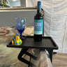 Black spa side table with wine, a glass & rubber duck