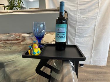 Black spa side table with wine, a glass & rubber duck