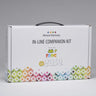 A white box titled "Mineral Harmony In-Line Companion Kit" with multi-colored geometric patterns on the bottom part in front of a white background
