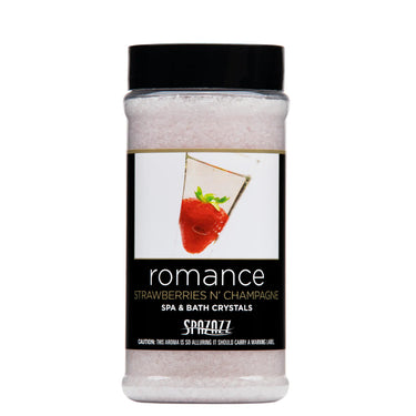 Bottle of 'romance strawberries n' champagne' spa and bath crystals with a black cap on a white background.