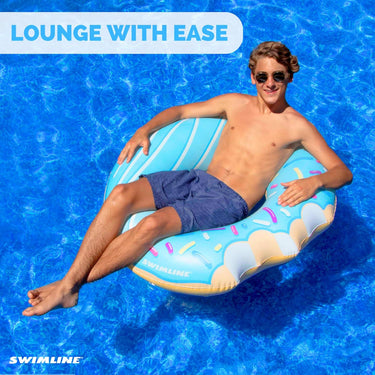 Young man lounging in a blue donut ring in the pool