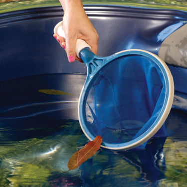 Blue life spa scoop with lady scooping a leaf from the water