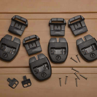 Black plastic clips and screws on a wooden surface