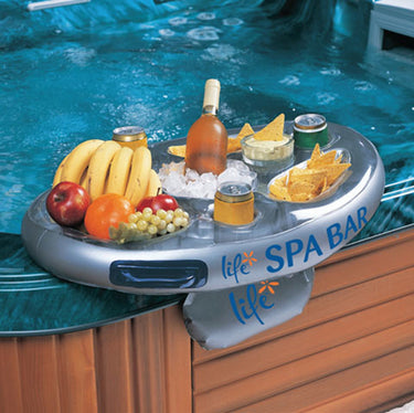Spa bar with drinks and snacks on a hot tub.