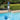 Easy Skim™ – Effortless Surface Cleaning for Pools & Spas. Pole not included - picture shows man using the easy skim in the pool. 
