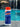 5lb container of pool shock on a concrete ledge beside a pool