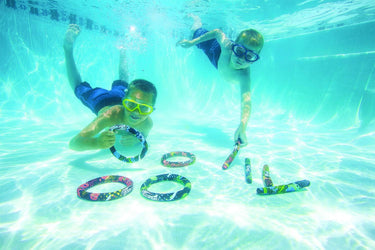 Active Xtreme Dive Sticks  4pk, with fun designs.  2 red, yellow, black and white. 2 green, blue, black and white. showing 2 children diving in the pool to retrieve the dive sticks.