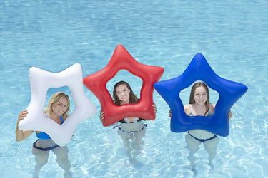 3 star ring floats - one red, one blue, one white - each one has a young woman holding it to show scale, standing in pool water.