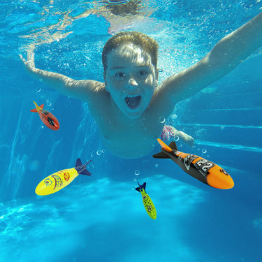 Glide N Dive Torpedoes - dive torpedoes shaped like fish. 4 pack comes in green, red, yellow and orange. Picture shows Fun day at the pool for the kids! Swimming underwater with the torpedoes.