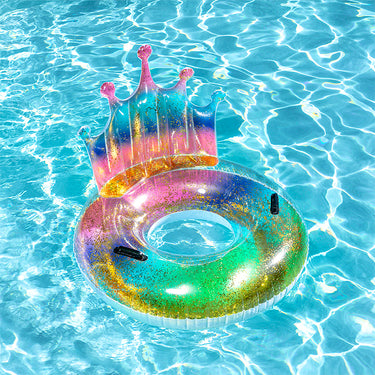 Colorful inflatable crown pool float on clear blue water
