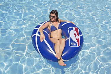 48″ NBA Tube. Blue with White design and NBA logo. Woman floating in water on it for scale.