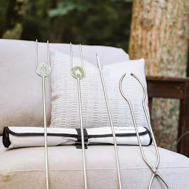 Decorative metal tools on a cushioned surface with a blurred natural background
