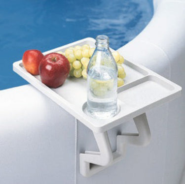 White side table on spa with fruit and bottle water