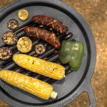 Grilled corn, sausages, and bell pepper on a cast iron grill pan.