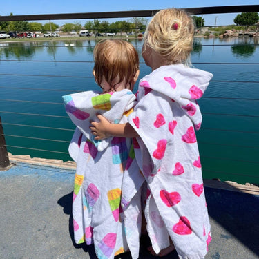 Two small girls wearing the popsicle and heart designs on hooded towel