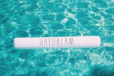 Jumbo inflatable noodle white with text daydream in water