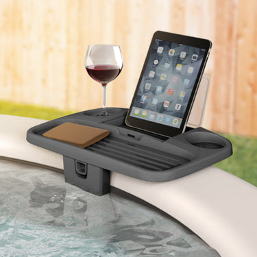 Dark gray adjustable side spa tray showing a glass of wine and electronic tablet